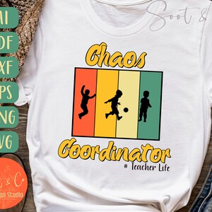 May include: White t-shirt with a graphic that reads "Chaos Coordinator" in yellow and black. The graphic features silhouettes of children playing in front of a retro color block design. The text "# Teacher Life" is below the main text.