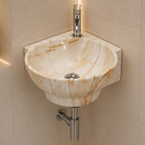 May include: A wall-mounted corner sink crafted from polished beige marble with prominent brown veining. The basin features a circular chrome drain and is paired with a vertical chrome faucet mounted on the rear ledge of the stone structure.