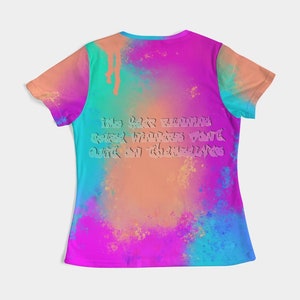 May include: A colorful t-shirt with a vibrant tie-dye design in shades of pink, blue, orange, and green. The back of the shirt features text in a stylized font. The shirt has short sleeves and a crew neck.
