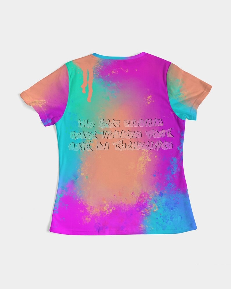 May include: A colorful t-shirt with a vibrant tie-dye design in shades of pink, blue, orange, and green. The back of the shirt features text in a stylized font. The shirt has short sleeves and a crew neck.