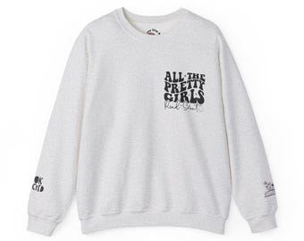 May include: A heather grey sweatshirt with a black graphic print that says "All the Pretty Girls" with the text "Read: Smart" underneath. The sweatshirt has a small logo on the left sleeve and a small graphic on the right sleeve.