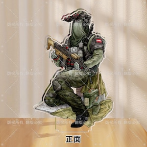May include: An illustration of a soldier in combat attire, kneeling and holding a rifle. The figure is clad in green and camouflage, with a helmet and night vision equipment. The text "正面" is at the bottom.