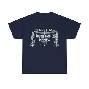 May include: Navy blue t-shirt with a white graphic of a vintage radio tower with the text "PERPETUAL TROUBLE SHOOTERS MANUAL" printed on it.