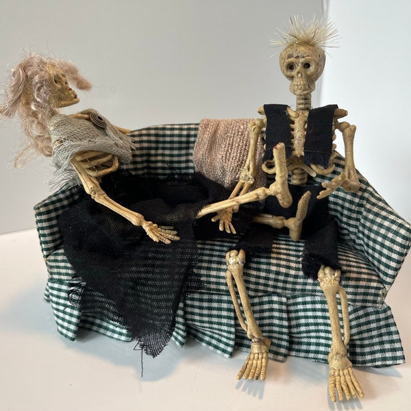 Miniature skeleton pair on couch