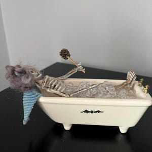 Miniature skeleton lady in bathtub