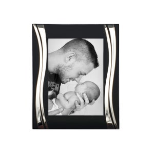 May include: Black picture frame with a silver wave design. The frame holds a black and white photo of a father and baby.