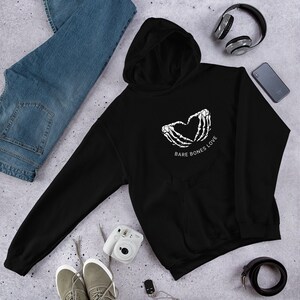 May include: Black hooded sweatshirt with a white graphic of two skeleton hands forming a heart shape with the text "Bare Bones Love" underneath.