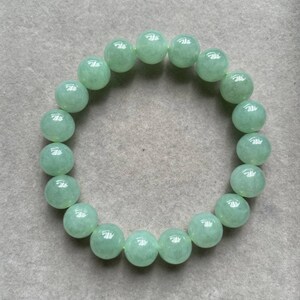 May include: A green jade bracelet with round beads.