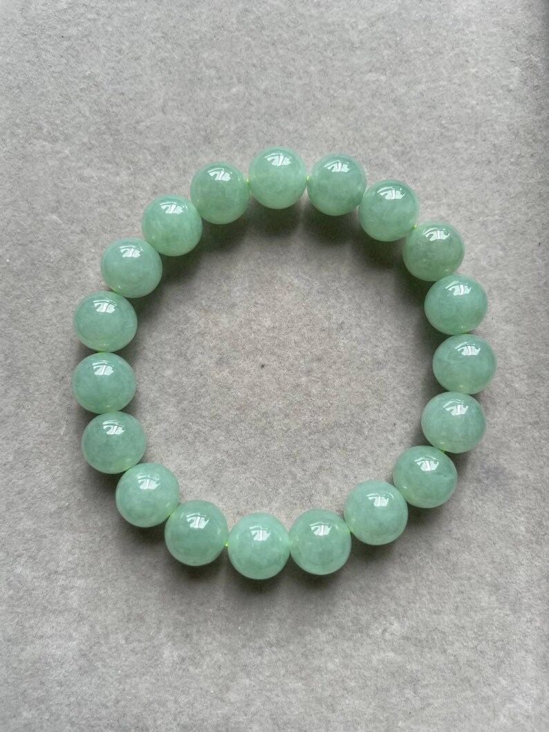 May include: A green jade bracelet with round beads.