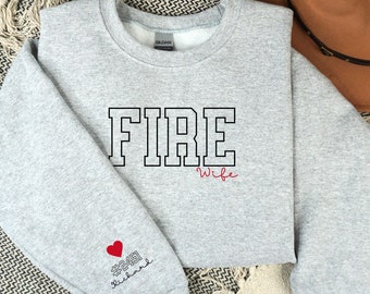 May include: Gray sweatshirt with the text "FIRE Wife" in black and "#2451 Richard" in red with a heart on the left sleeve.