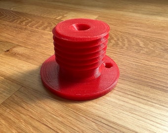 May include: A red 3D printed object with a threaded base and a circular top with a small hole in the center.