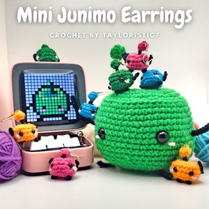 May include: Crocheted Junimo earrings in various colors, including green, pink, blue, and orange. The earrings are displayed on a small speaker with a pixelated image of a green apple on the screen. The text "Mini Junimo Earrings" and "CROCHET BY TAYLORISTIC7" is visible in the image.