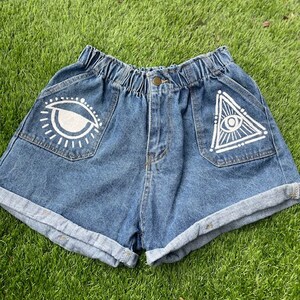 Upcycled All Seeing Eye High Waisted Jean Shorts.