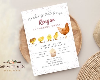 May include: A birthday party invitation with a watercolor illustration of a hen and chicks. The invitation reads "Calling all peeps, Reagan is turning three!" and includes party details. The invitation is on a wooden tray.