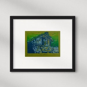 Linocut greeting card with traditional norwegian cabin and woman. Signed and numbered, in colors green blue and lightblue, green card