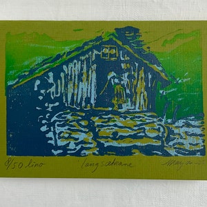 Linocut greeting card with traditional norwegian cabin and woman. Signed and numbered, in colors green blue and lightblue, green card