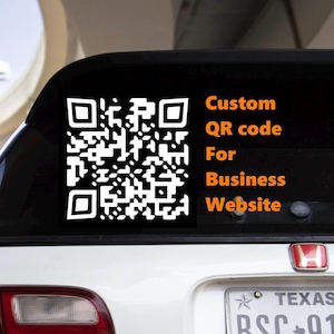 May include: A white QR code sticker on a car window. The sticker has a black background with a white QR code and the text "Custom QR code For Business Website" in orange.