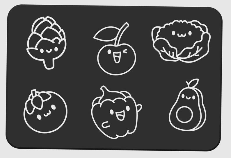 May include: A black rectangular surface with six white line-drawn illustrations of smiling fruits and vegetables. The illustrations include an artichoke, cherry, cauliflower, tomato, bell pepper, and avocado.