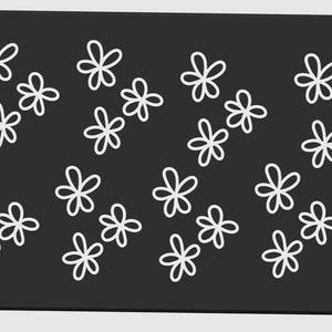 May include: A rectangular, dark gray surface with a pattern of white, five-petal flower shapes. The flowers are evenly spaced across the surface, creating a simple, yet elegant design. The edges of the surface are rounded.