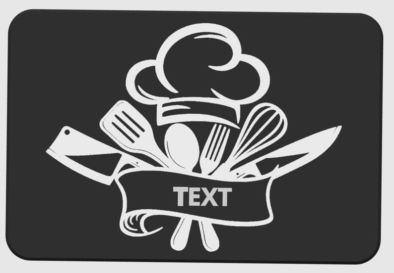May include: A white chef's hat and kitchen utensils design on a black background. The design includes a chef's hat, spatula, spoon, fork, whisk, and knife. The word "TEXT" is in a banner below the utensils.
