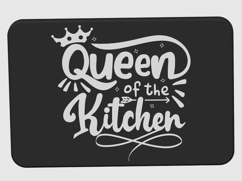 May include: Black rectangular kitchen mat with the words "Queen of the Kitchen" in white script. The design includes a crown, arrow, and decorative flourishes, perfect for a kitchen.