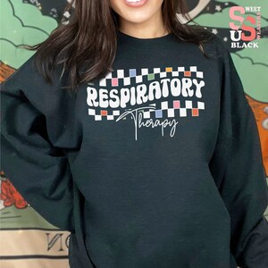 a woman wearing a black sweatshirt with the words respiratory on it