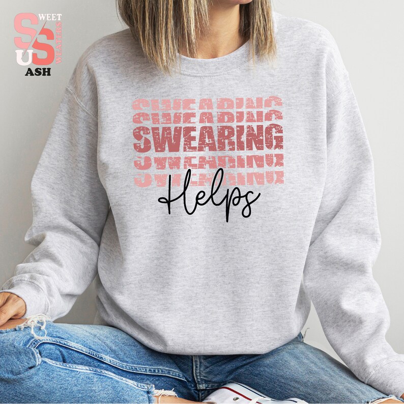 a woman wearing a sweatshirt with the words, she is wearing shoes