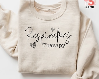 May include: A beige sweatshirt with the text "Respiratory Therapy" in black script. Two black hearts with a leopard print design are above and below the text.