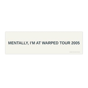 May include: A rectangular sticker with a cream-colored background and dark gray text that reads MENTALLY, I'M AT WARPED TOUR 2005. The small text PAPER WOOVES STUDIO is printed in the bottom right corner of the sticker design.