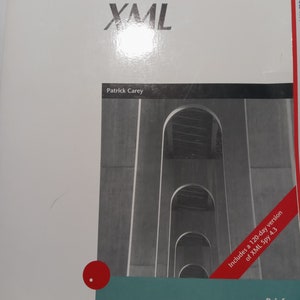 May include: A book cover with a white background and the title "XML" in large, bold, black letters. The author's name, "Patrick Carey", is printed below the title in smaller black letters. The cover also features a photo of a bridge with a red banner that says "Includes a 120-day version of XML Spy 4.3" and the word "Brief" in black letters.