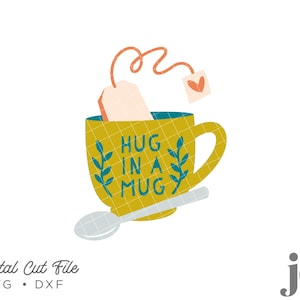May include: A yellow mug with a teal green design that says "Hug in a Mug" and a tea bag with a heart on it. A spoon is next to the mug.