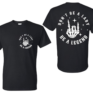 Don&#39;t Be A Lady | Be A Legend | Rock On | Skeleton Hands | White Decals | Black Tee | Unisex | Oversized Tee | Punk Tee | Graphic Tee