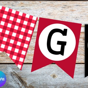 May include: Red and white gingham banner with the letters "G" and "I" in black circles on a red and black background. The banner is strung on a wooden surface.