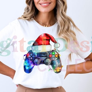 May include: A white t-shirt with a colorful illustration of a video game controller wearing a Santa hat. The controller is decorated with Christmas lights.