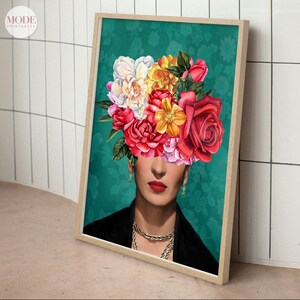 May include: A framed print of a woman's face with a colorful floral arrangement covering her head. The background is a teal green with a floral pattern. The woman is wearing a black jacket and a gold necklace.
