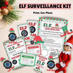 以下が含まれることがあります： 赤と緑のアクセントが施されたお祝いの妖精監視キット。このキットには、「いたずら通知」や「頑張って！」などのテキストが書かれた印刷可能なカードと、妖精をテーマにした監視カメラが含まれています。「妖精監視キット」というテキストが上部にあります。