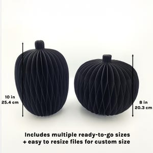 May include: Two black paper pumpkins, one 10 inches tall and the other 8 inches tall. The pumpkins have a ribbed design and a stem at the top. Text at the bottom reads "Includes multiple ready-to-go sizes + easy to resize files for custom size."