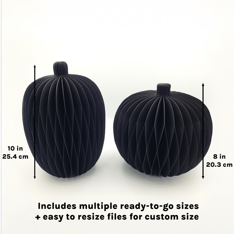 May include: Two black paper pumpkins, one 10 inches tall and the other 8 inches tall. The pumpkins have a ribbed design and a stem at the top. Text at the bottom reads "Includes multiple ready-to-go sizes + easy to resize files for custom size."