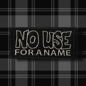 May include: Black and white embroidered patch with the text "NO USE FOR A NAME" in a stylized font.