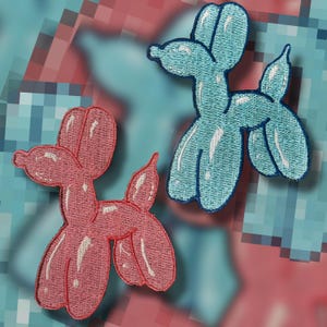 May include: Two embroidered patches in the shape of balloon animals. One is light blue with a dark blue outline, and the other is pink with a white outline. The patches are on a pixelated background of blue and pink.