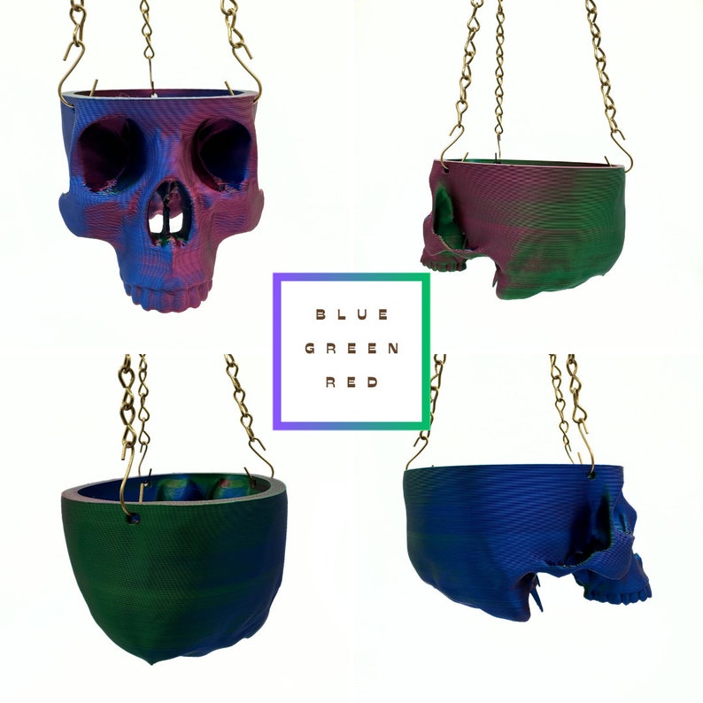 May include: Four hanging skull planters in different color combinations. The skulls are blue, green, and red. The planters are made of a textured material and have a chain for hanging.
