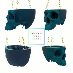 May include: Four teal skull-shaped hanging planters with gold chains. The text "EMERALD GREEN BLACK" is visible in the center of the image.