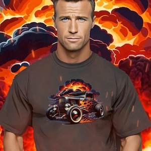 Op de afbeelding: Bruin t-shirt met een afbeelding van een vintage hot rod in brand. De afbeelding toont de auto met vlammen en rook, tegen een achtergrond van een explosie. Het t-shirt heeft korte mouwen en een ronde hals.