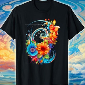 Könnte beinhalten: Schwarzes T-Shirt mit einem lebendigen Blumendesign und einem Spiralelement. Das Kunstwerk zeigt orange, blaue und rote Blumen mit grünen Blättern. Das Design ist vor einem schwarzen Hintergrund platziert und erzeugt einen auffälligen Kontrast.