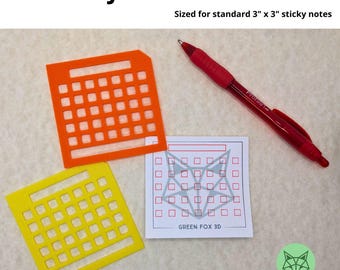 May include: Two orange and yellow stencils for creating a calendar grid on 3x3 inch sticky notes. The stencils are sized for standard sticky notes. The text "GREEN FOX 3D" is printed on the white paper.