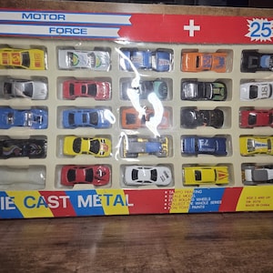May include: A boxed set of 25 die-cast metal toy cars in various colours, including red, yellow, blue, and black. The box features the text "MOTOR FORCE" and "DIE CAST METAL". Each car is approximately 5-7 cm long.