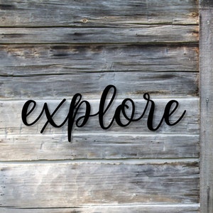 May include: A weathered wooden door and wall with the word "explore" in a cursive font. The door is made of vertical wooden planks with a dark brown finish. The wall is made of horizontal wooden planks with a gray finish.