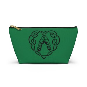 May include: Green zippered pouch with a black Celtic knot design in the shape of a heart. The knot design includes two black Irish dancing shoes.
