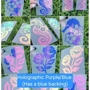 May include: A collection of holographic vinyl decals featuring seahorse and rose designs with floral patterns. The decals display shifting iridescent colors including blue, purple, pink, and yellow, presented on clear backing sheets.