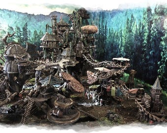 May include: A detailed miniature fantasy village with multiple wooden structures, bridges, and towers. The village is set in a forest with a backdrop of green trees and a blue sky. The structures have a rustic, aged appearance.